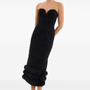 Front view of the black adrena midi dress by Rebecca Vallance. Fitted strapless dress with a sweetheart neckline and voluminous detail at the bottom.