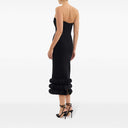 Back view of the black adrena midi dress by Rebecca Vallance. Fitted strapless dress with a sweetheart neckline and voluminous details at the bottom.