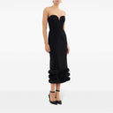 Front view of the black adrena midi dress by Rebecca Vallance. Fitted strapless dress with a sweetheart neckline and voluminous detail at the bottom.