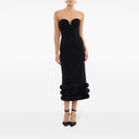 Front view of the black adrena midi dress by Rebecca Vallance. Fitted strapless dress with a sweetheart neckline and voluminous detail at the bottom.